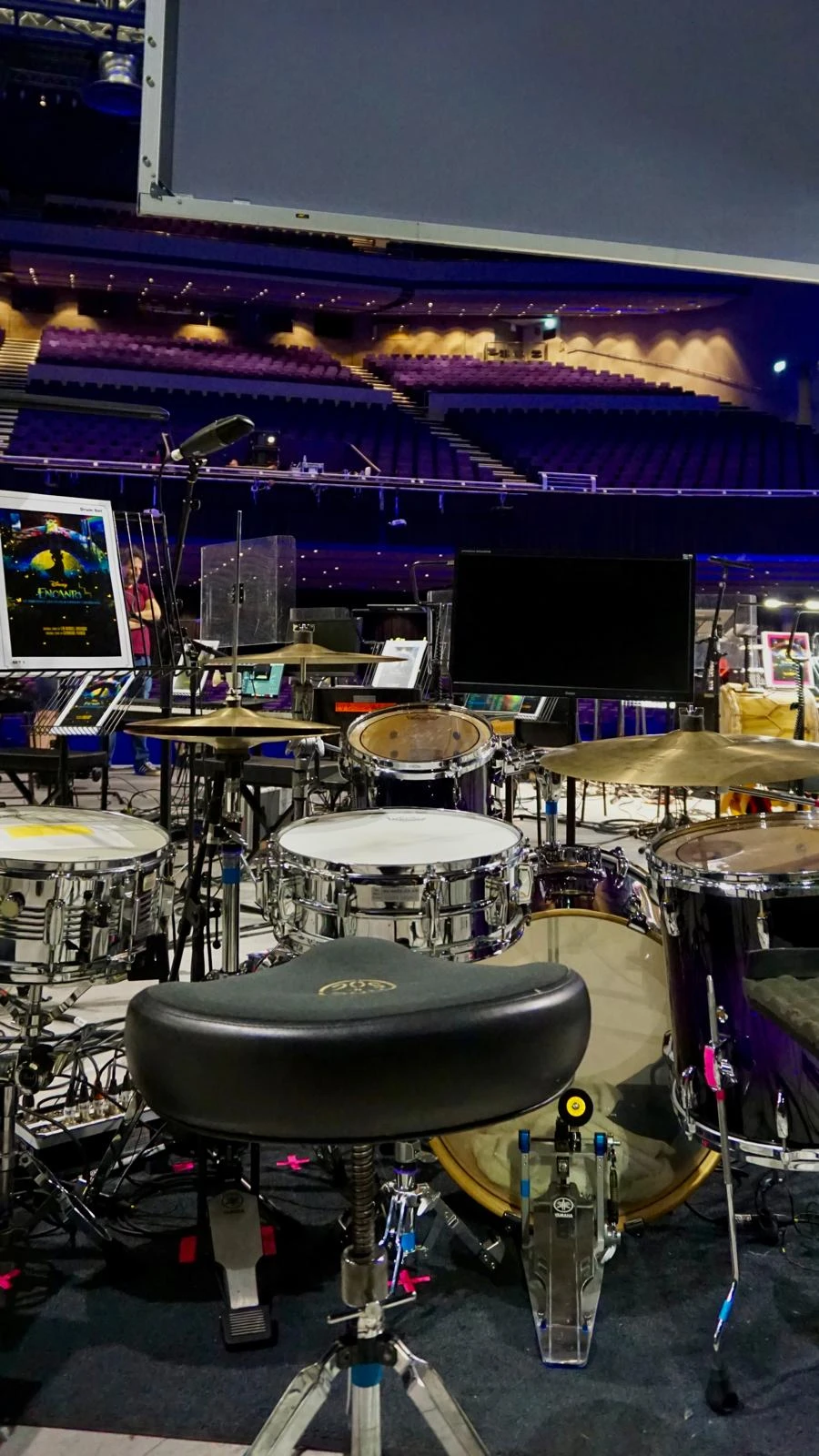 Backstage drum kit prep with cases and hardware ready for changeover